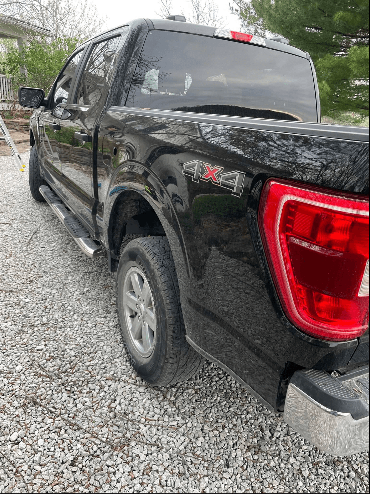 Black Ford F-150 4x4 rear three-quarter view after a ceramic coating in Olathe, KS